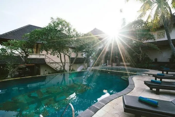 Lush private luxury villa courtyard in Ubud Bali with tranquil water pool and tropical flora