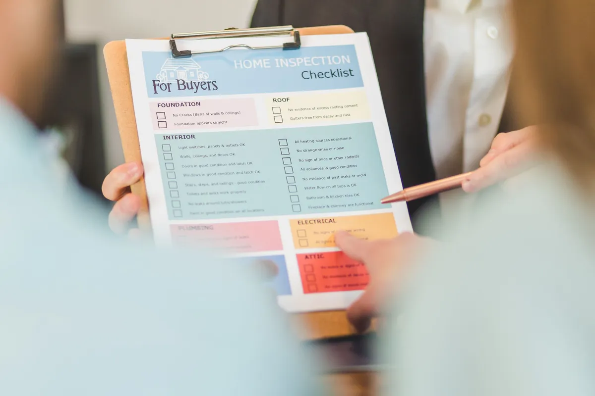 Property inspection checklist being reviewed by hand