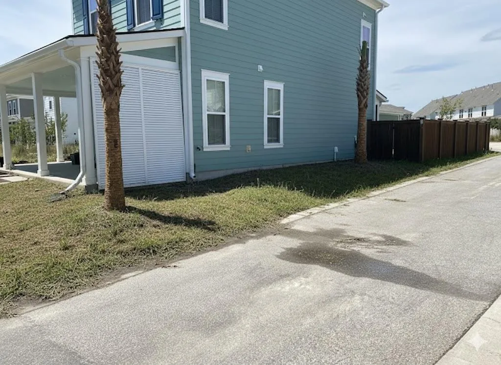 Terraced backyard with cut-stone retaining walls and herringbone paver walkways in soft mid-morning light.