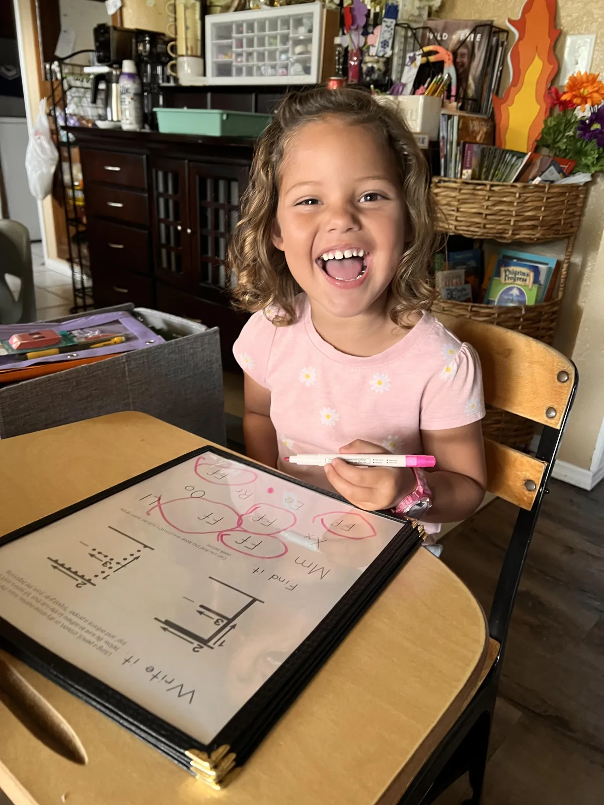 Girl stretches to the side while watching teacher on large screen TV