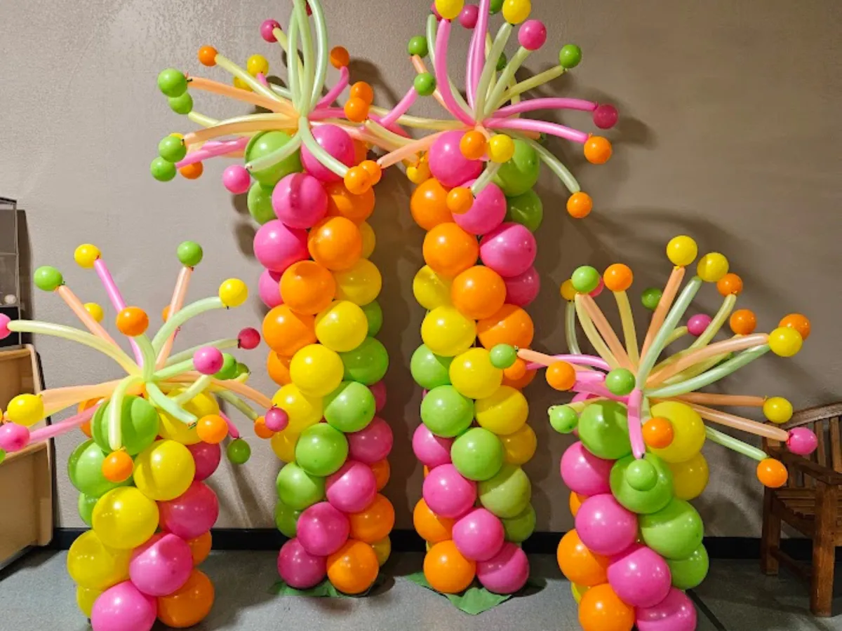 Colorful balloon columns with tropical palm tree design