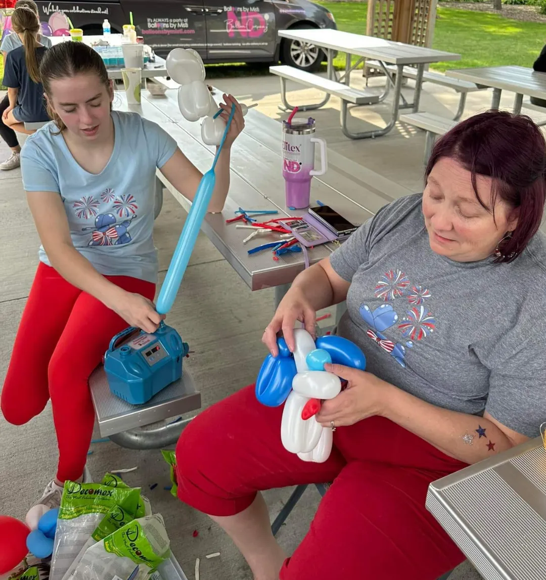 Balloon twisting at an outdoor event in Grand Forks ND with custom balloon creations