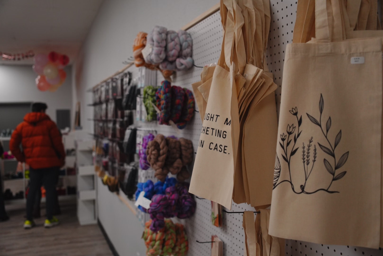 Bundles of locally sourced Alaskan wool and qiviut displayed on a rustic wooden shelf, with natural textures and subtle color variations. The fibers are soft, fluffy, and evoke the spirit of Alaska’s wilderness.