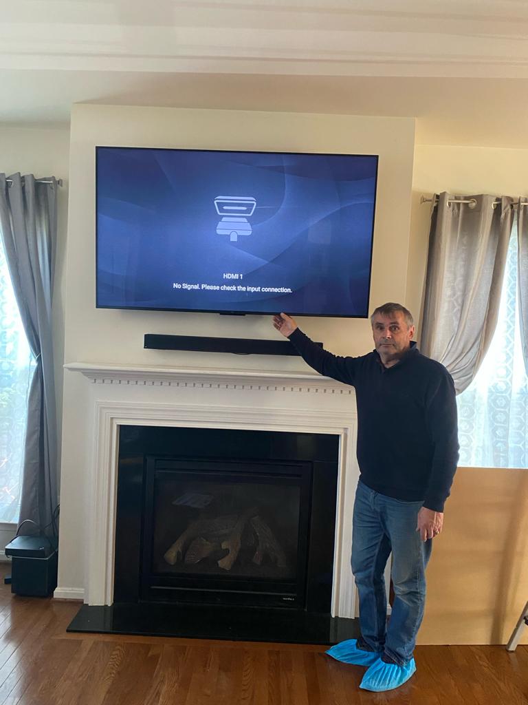 TV mounted above fireplace in Annandale VA