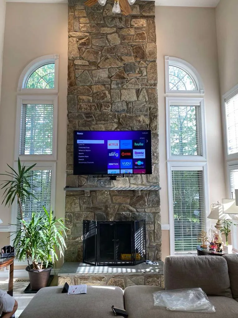 TV mounted above fireplace in Fair Lakes Virginia