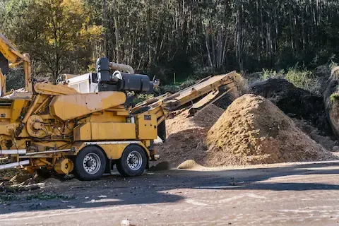 Wood chipper processing tree debris by Carol Stream Tree Care.