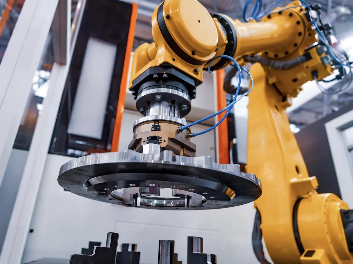 Yellow robotic arm precision manufacturing