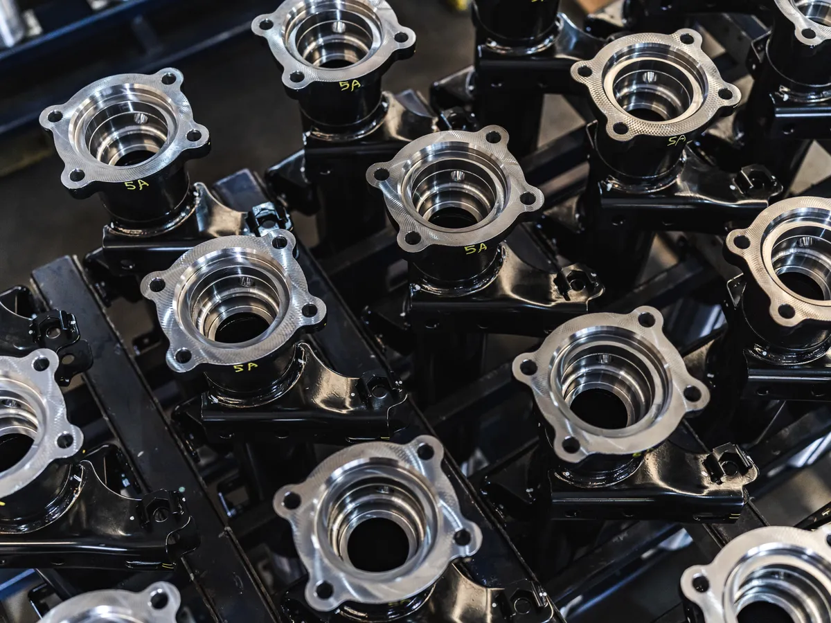 Die casting metal parts on an assembly line