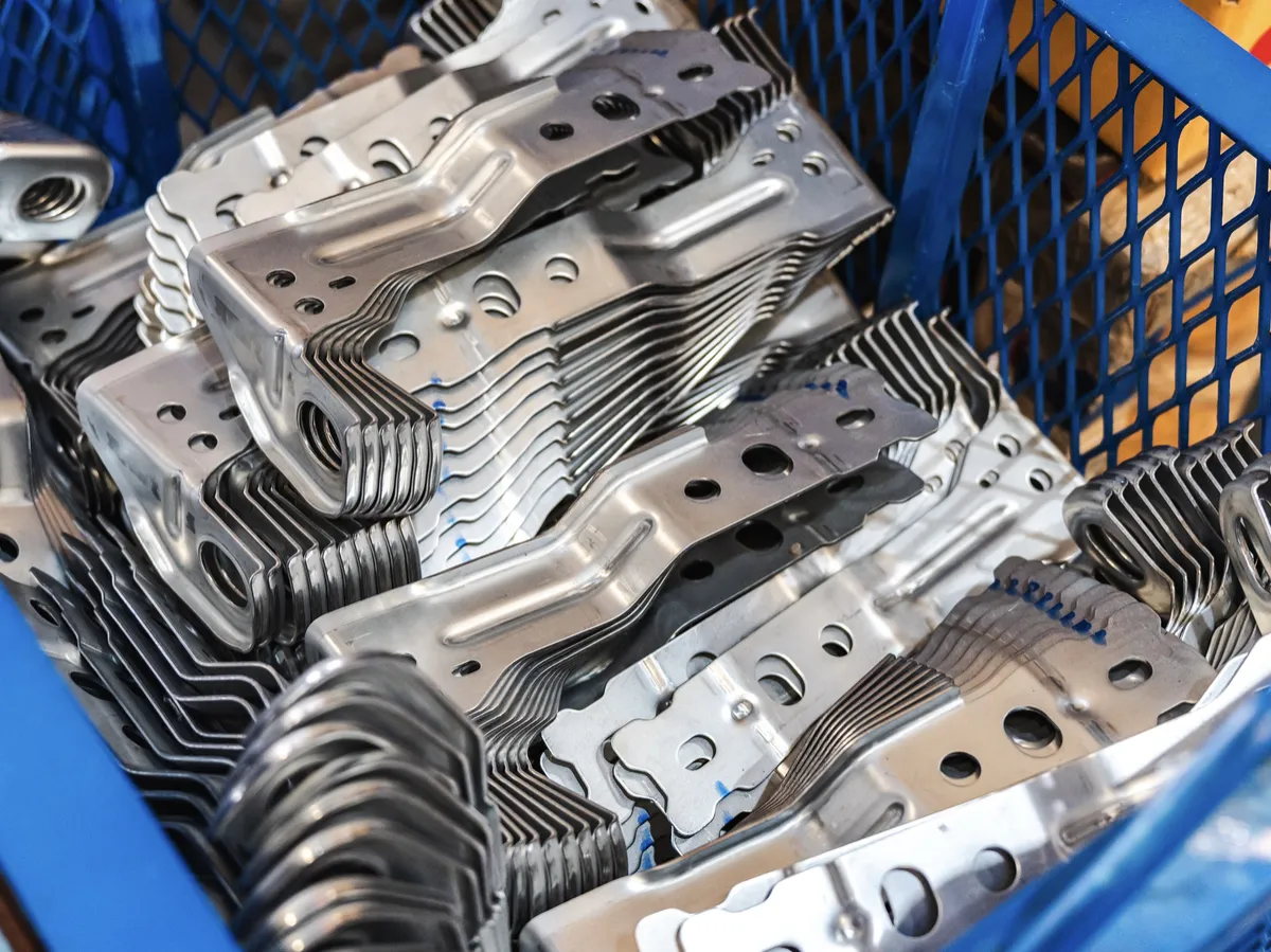 Shiny metal brackets produced in a manufacturing plant