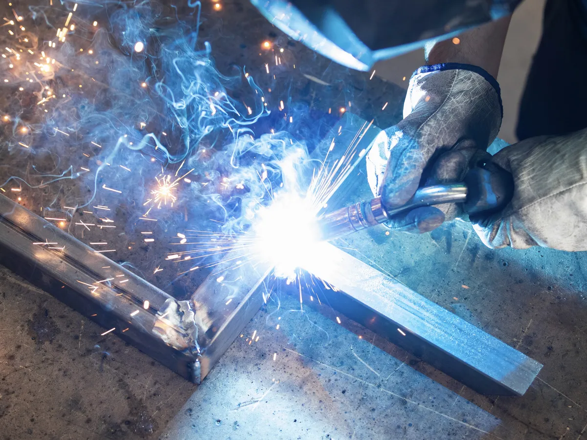 Metal being welded in an industrial environment