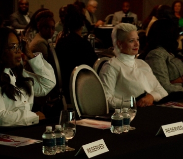 Brigitta Hoeferle and Oprah Winfrey sharing the stage as featured speakers at an event in Las Vegas, speaking on business strategies, mindset and communication.