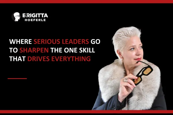 Brigitta Hoeferle in a thoughtful pose holding glasses, representing the best leadership qualities that drive high-performance results
