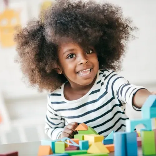 Children playing and learning at Learn & Play Child Center, utilizing The Creative Curriculum® for early childhood education.