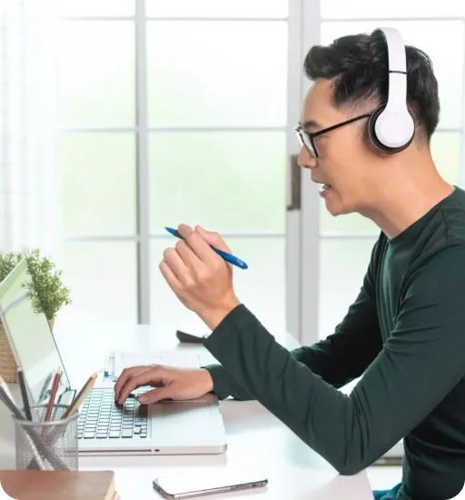 businessman wearing headphones working remotely from home