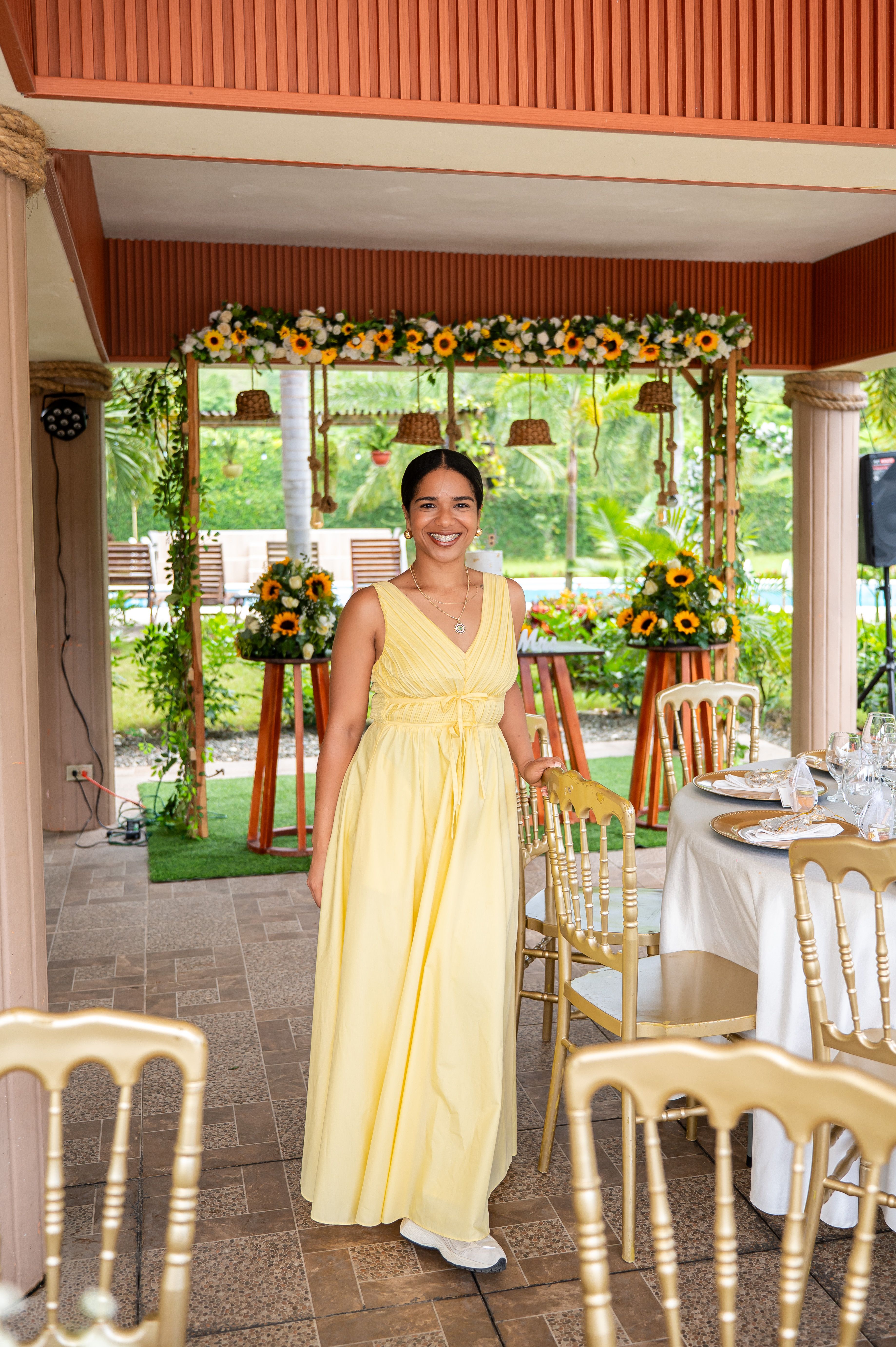 Portrait of Carmenzina in a yellow dress against a green background