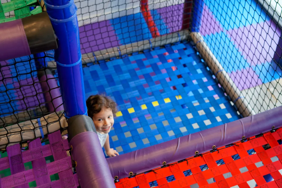 Kids playing together at Parents Night Out inside Wild Child indoor playground in Bastrop, TX