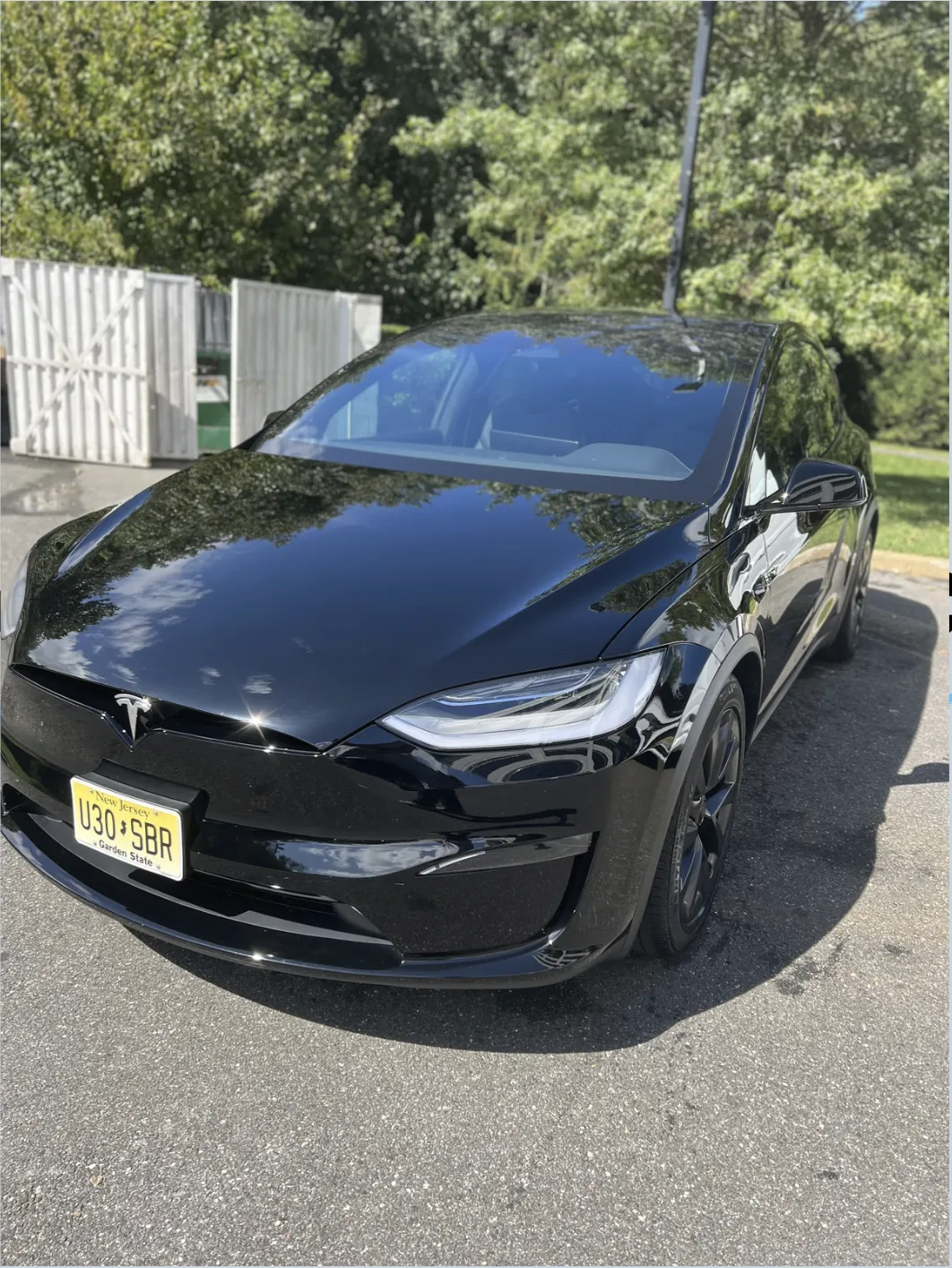 Mirror-like finish after professional paint correction on a black Tesla Model X in South Jersey.