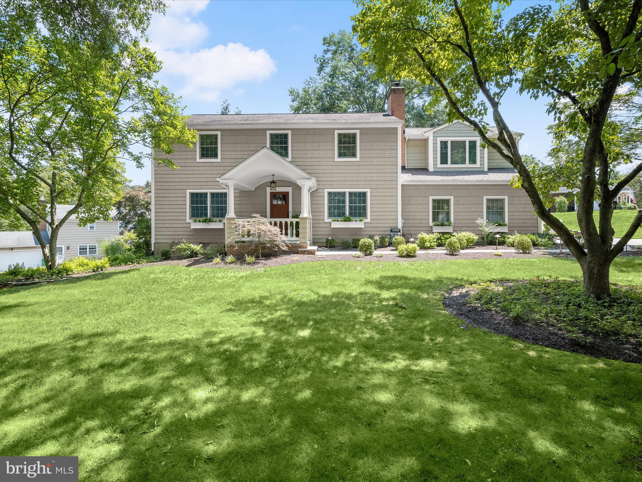 Harbor-front shot for Anne Arundel: calm water, piers and coastal homes at golden hour; atmospheric composition evokes lifestyle benefits of the neighborhood.