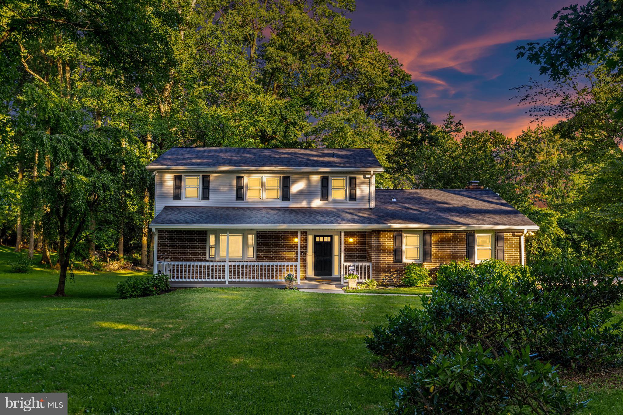 Harbor-front shot for Anne Arundel: calm water, piers and coastal homes at golden hour; atmospheric composition evokes lifestyle benefits of the neighborhood.