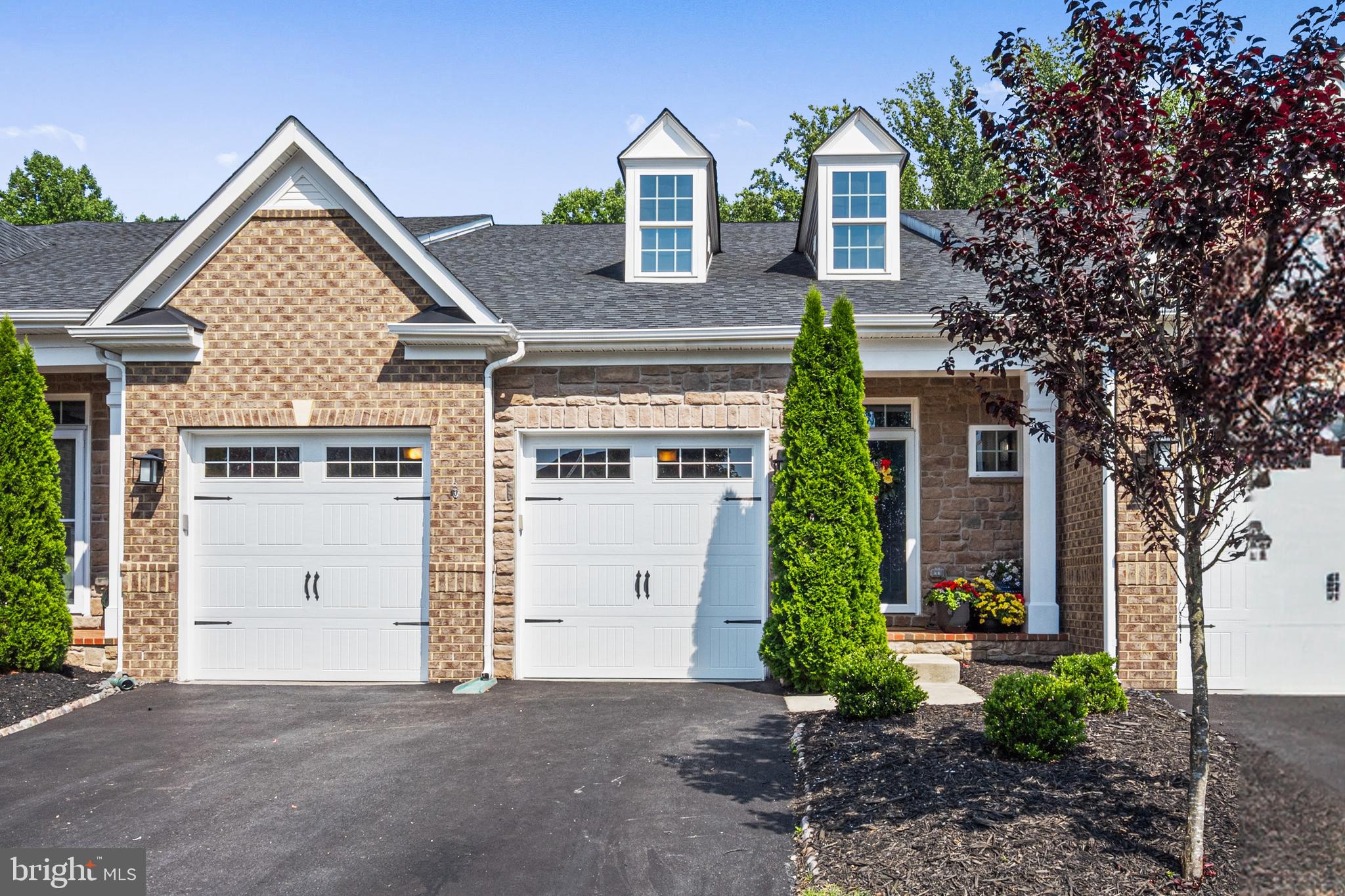 Harbor-front shot for Anne Arundel: calm water, piers and coastal homes at golden hour; atmospheric composition evokes lifestyle benefits of the neighborhood.