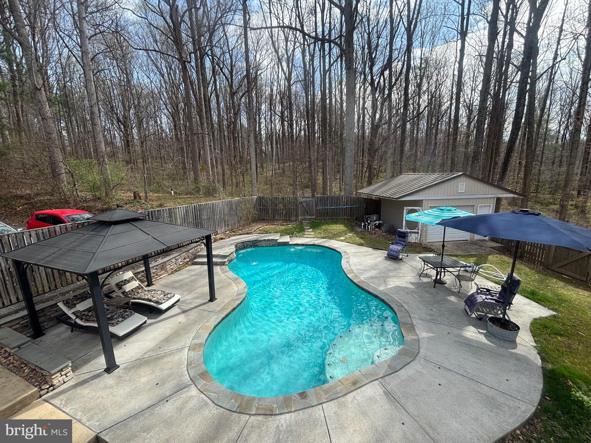Harbor-front shot for Anne Arundel: calm water, piers and coastal homes at golden hour; atmospheric composition evokes lifestyle benefits of the neighborhood.