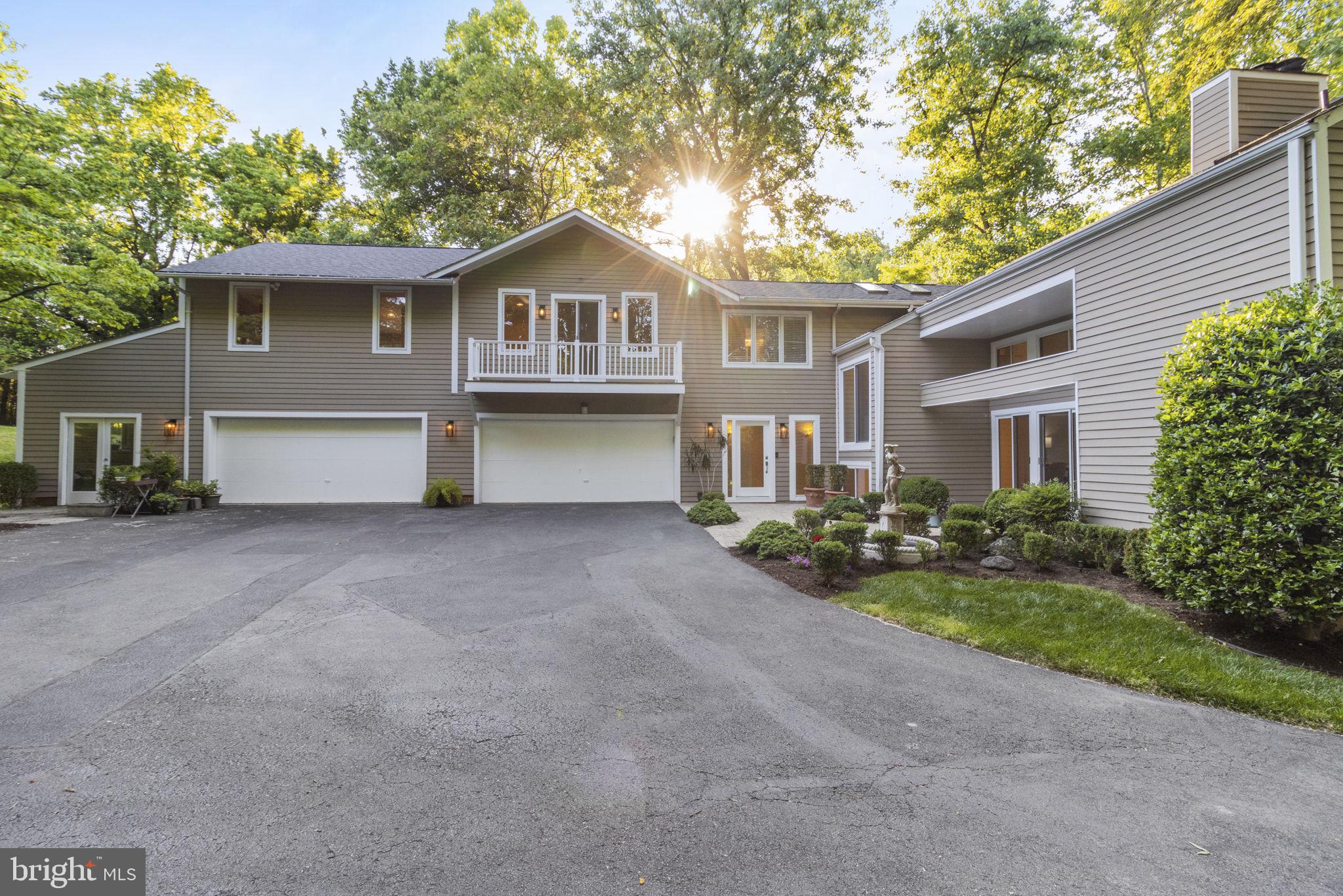 Harbor-front shot for Anne Arundel: calm water, piers and coastal homes at golden hour; atmospheric composition evokes lifestyle benefits of the neighborhood.