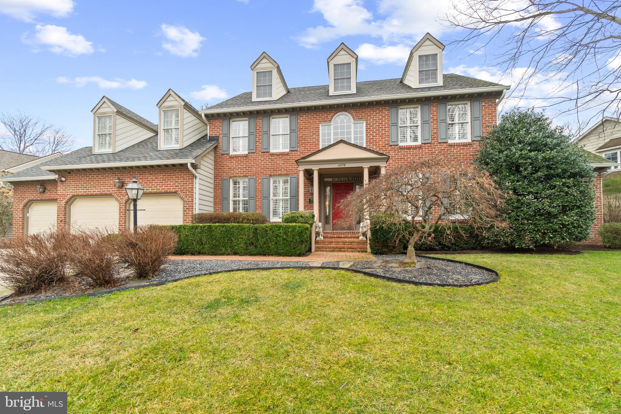 Harbor-front shot for Anne Arundel: calm water, piers and coastal homes at golden hour; atmospheric composition evokes lifestyle benefits of the neighborhood.
