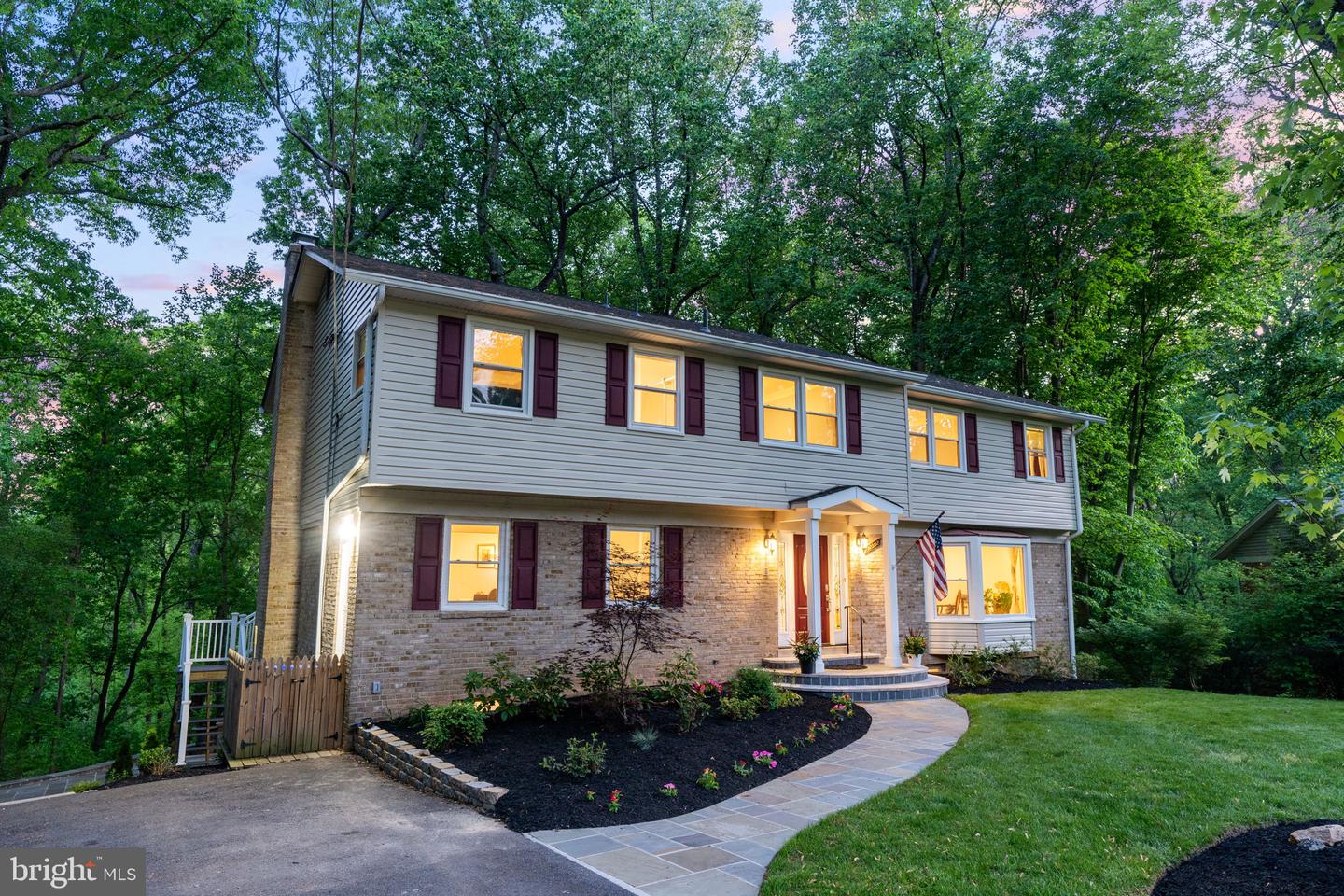 Harbor-front shot for Anne Arundel: calm water, piers and coastal homes at golden hour; atmospheric composition evokes lifestyle benefits of the neighborhood.