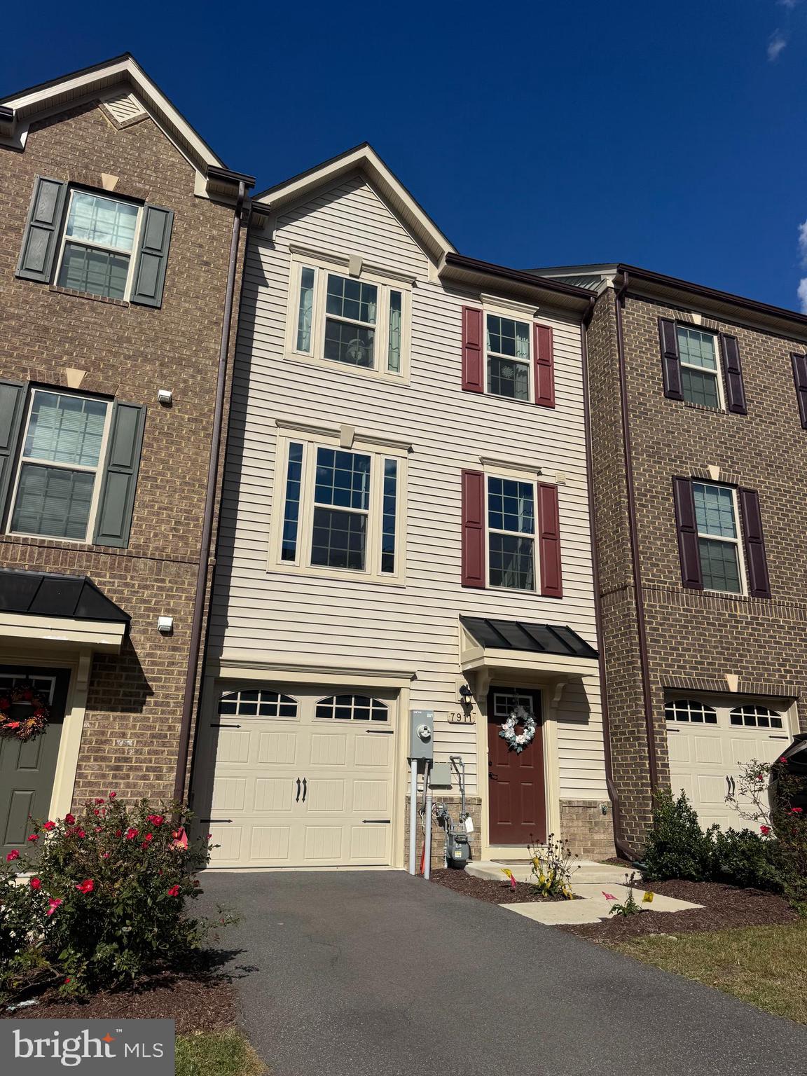Harbor-front shot for Anne Arundel: calm water, piers and coastal homes at golden hour; atmospheric composition evokes lifestyle benefits of the neighborhood.
