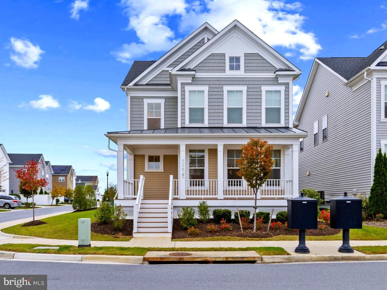 Harbor-front shot for Anne Arundel: calm water, piers and coastal homes at golden hour; atmospheric composition evokes lifestyle benefits of the neighborhood.