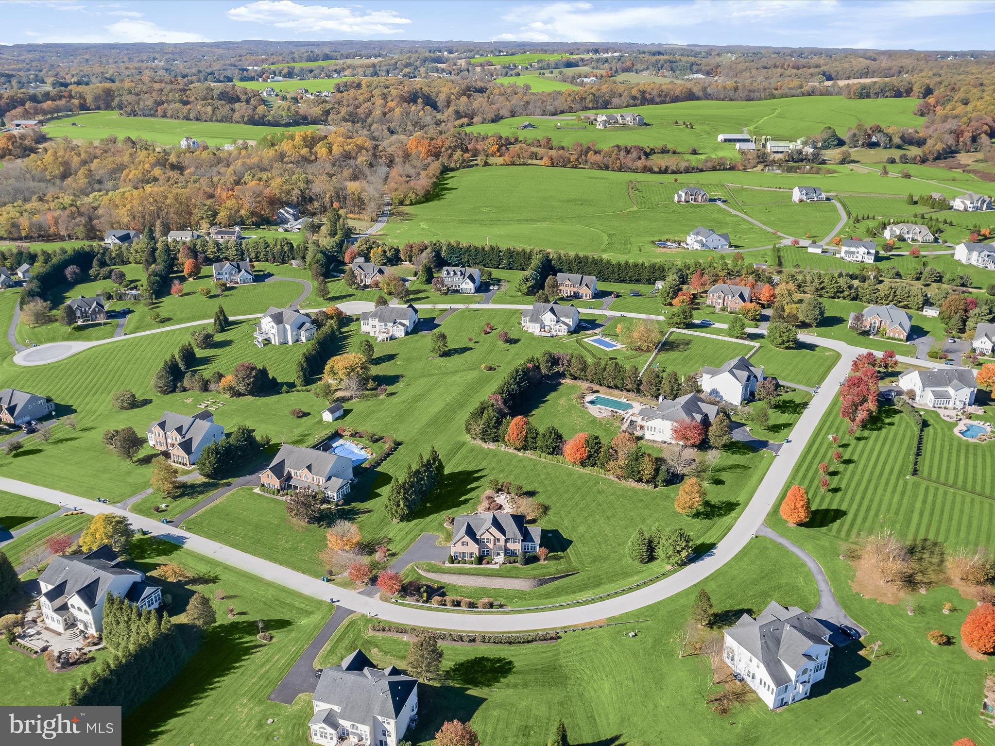 Harbor-front shot for Anne Arundel: calm water, piers and coastal homes at golden hour; atmospheric composition evokes lifestyle benefits of the neighborhood.