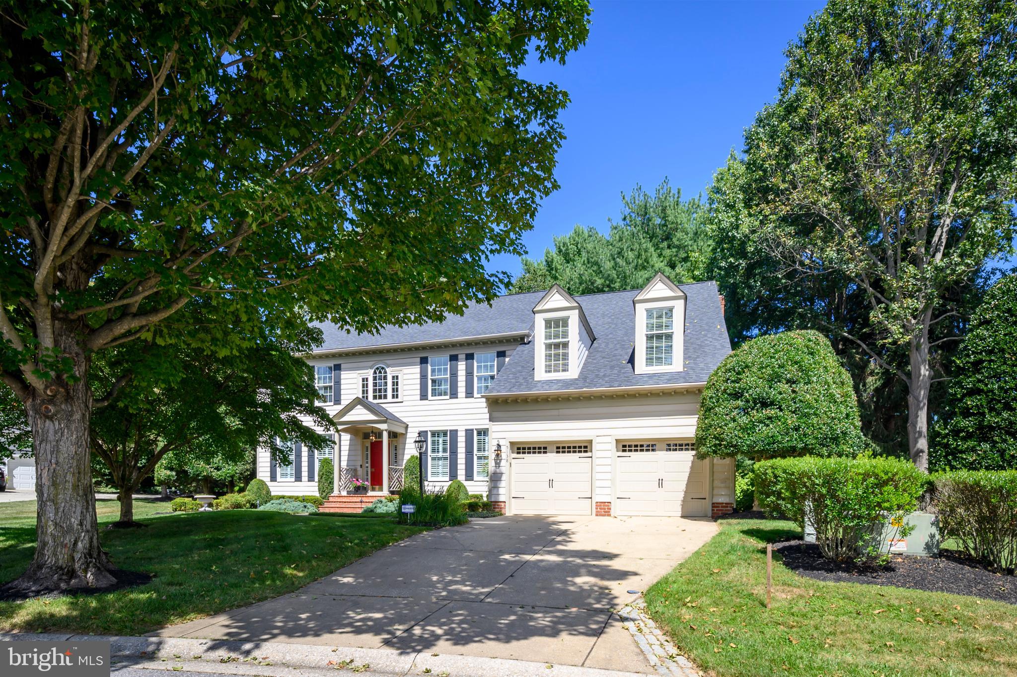 Harbor-front shot for Anne Arundel: calm water, piers and coastal homes at golden hour; atmospheric composition evokes lifestyle benefits of the neighborhood.