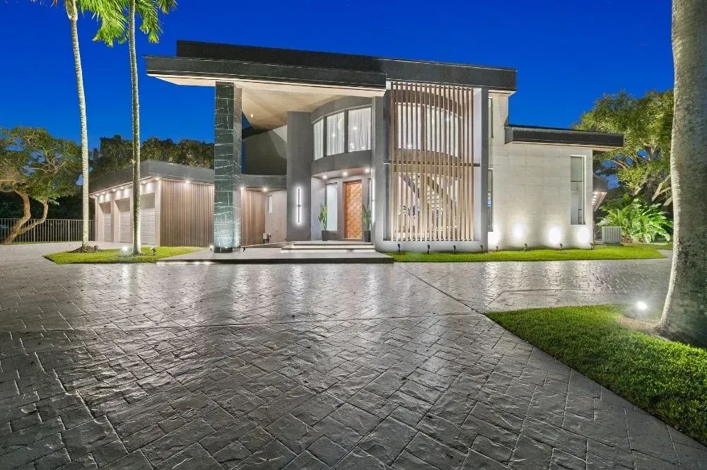 Weston residence with three-car garage and manicured lawn