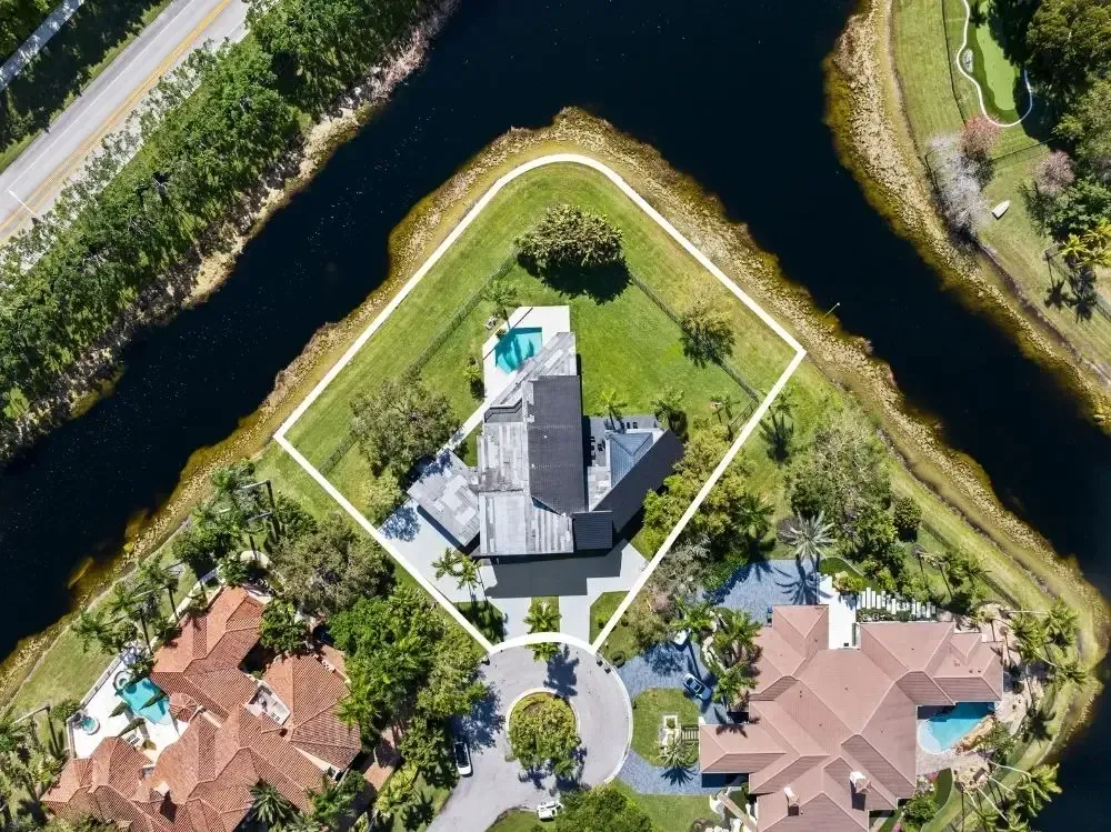 Two-story Weston home with paver driveway and lush landscaping