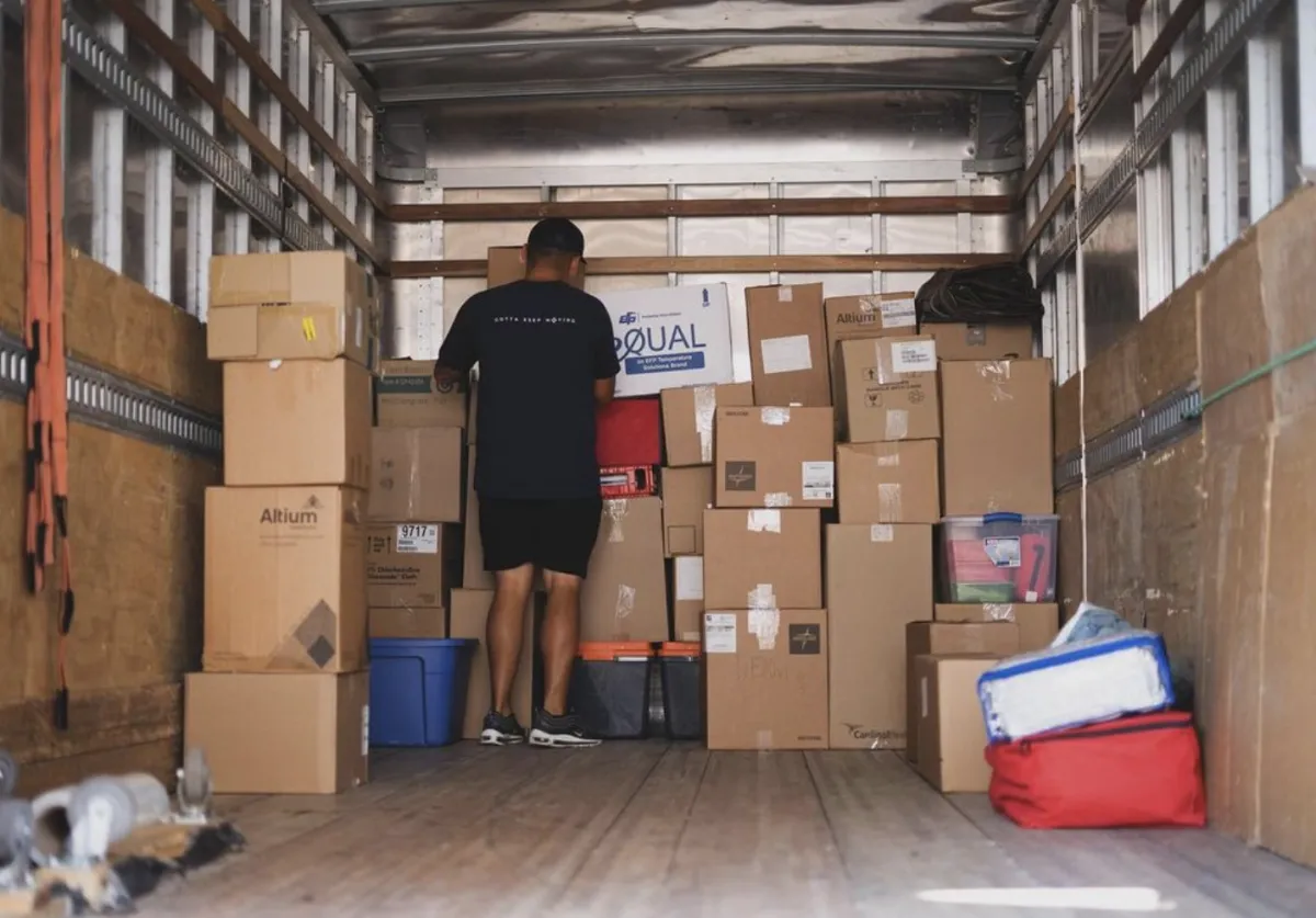 packing moving boxes in back of truck