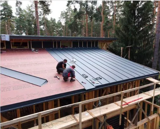 two men installing metal roof