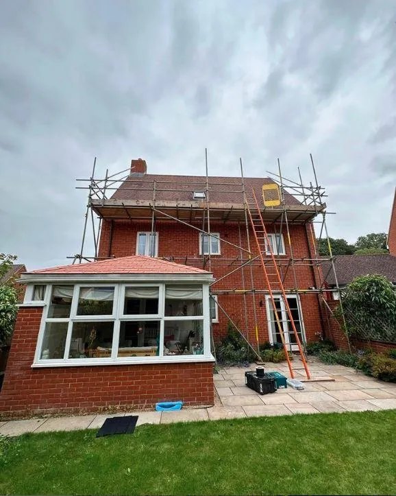 house with scaffolding for roof repair