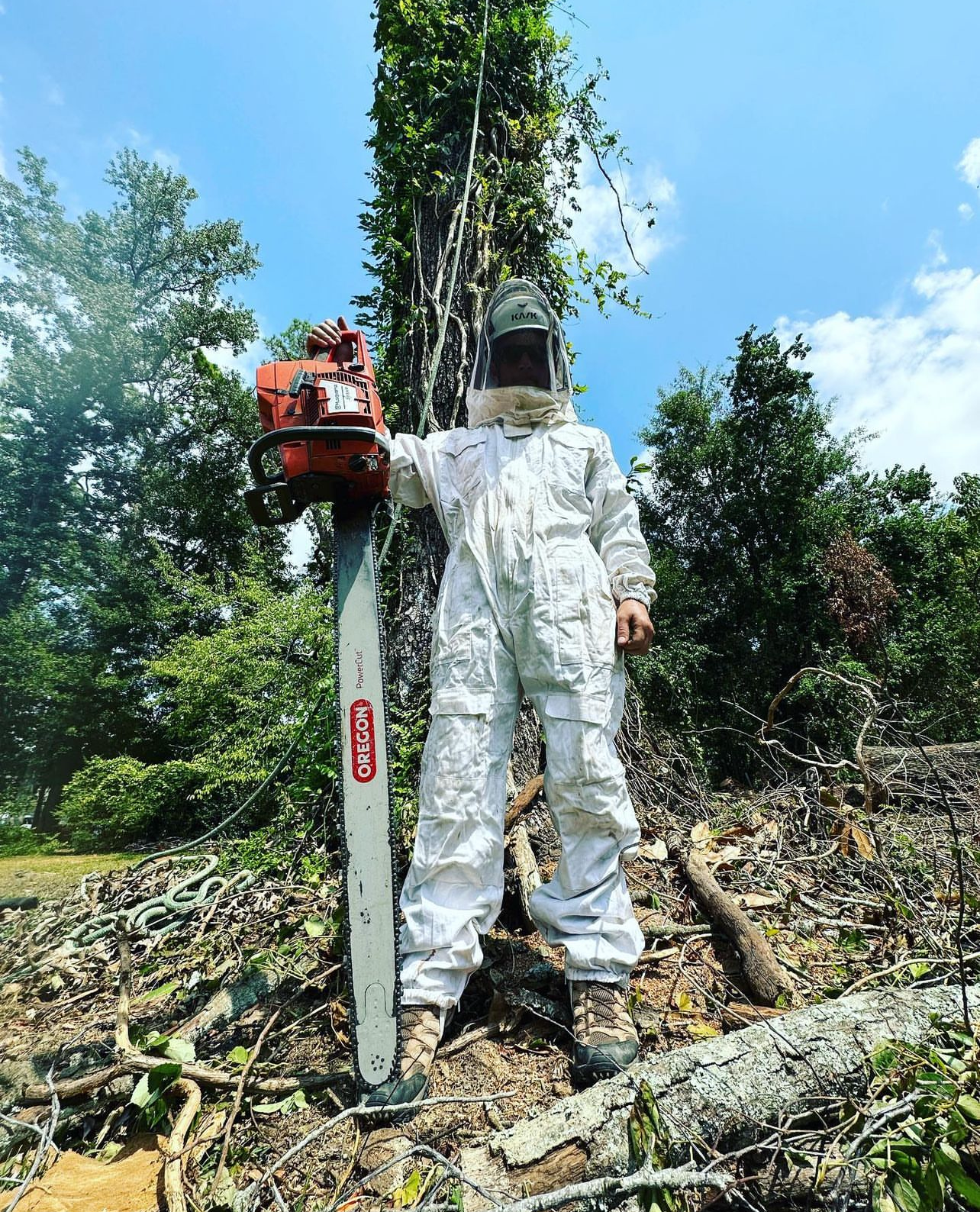 arborist posing for a photo holding a chainsaw