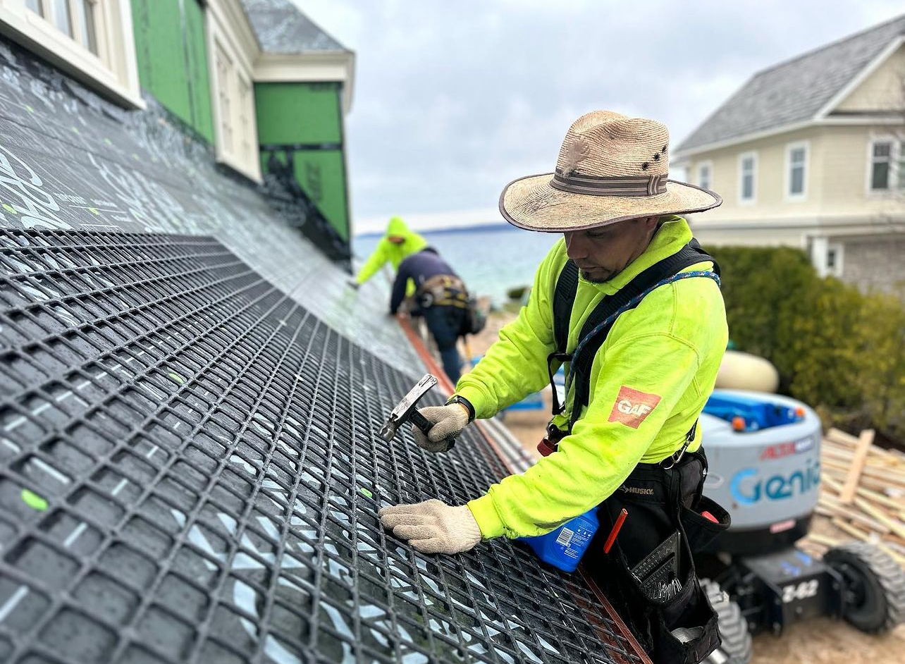 man installing a new roof