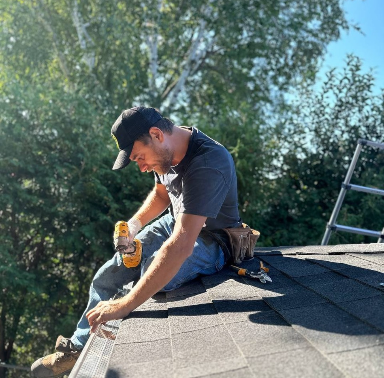 man reinstalling gutters