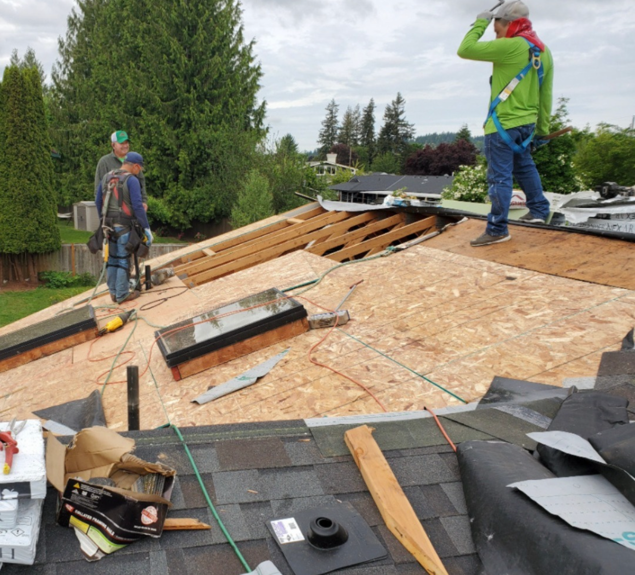 three roofers installing a new roof