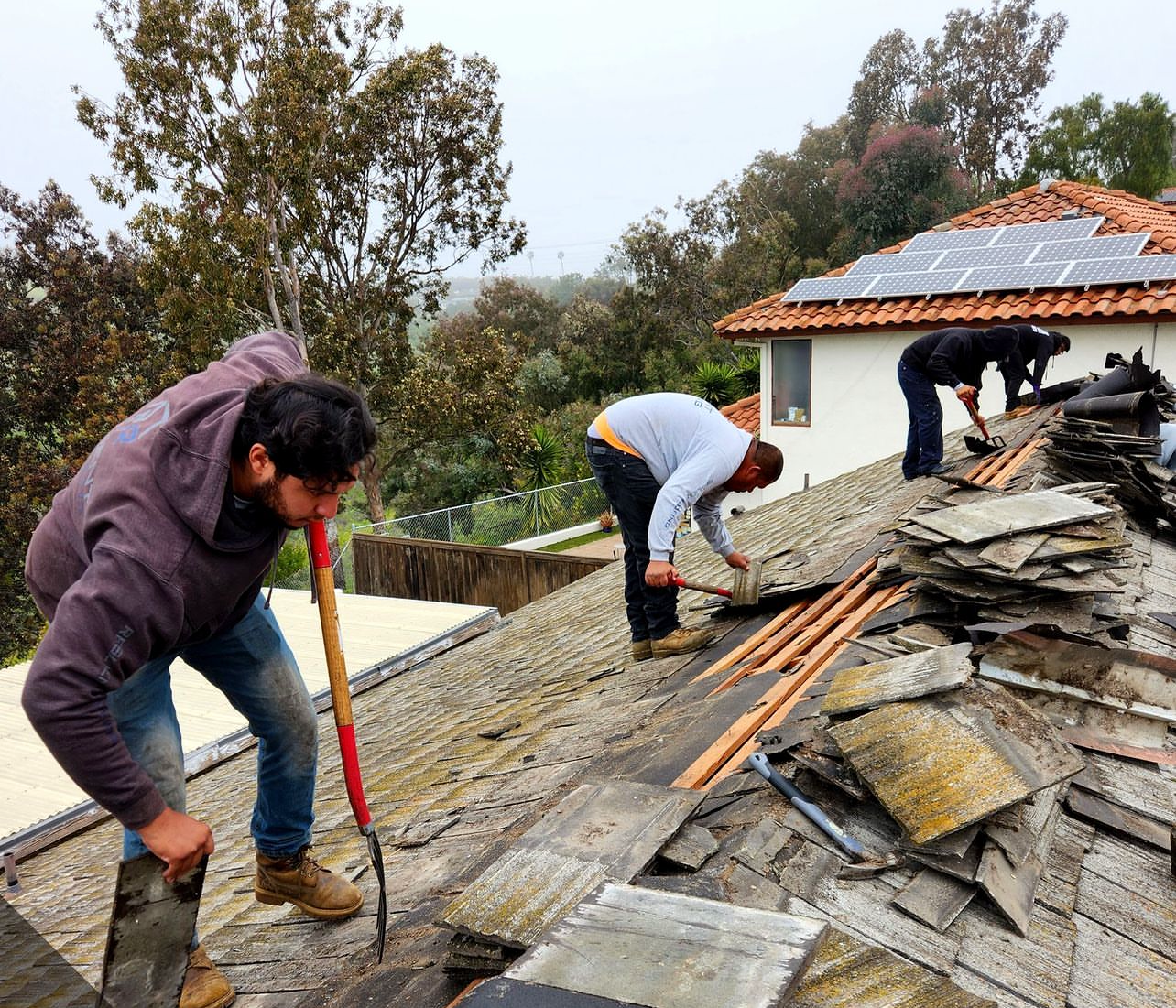 our roofers tearing off an old roof