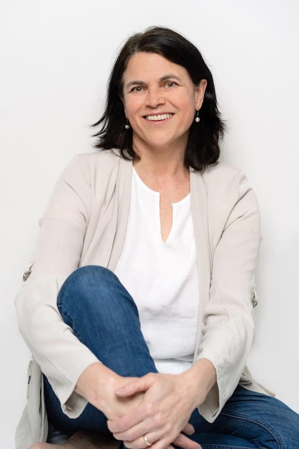 Gabrielle Taylor, founder and relationship coach, smiling warmly, seated in a calm, welcoming space.