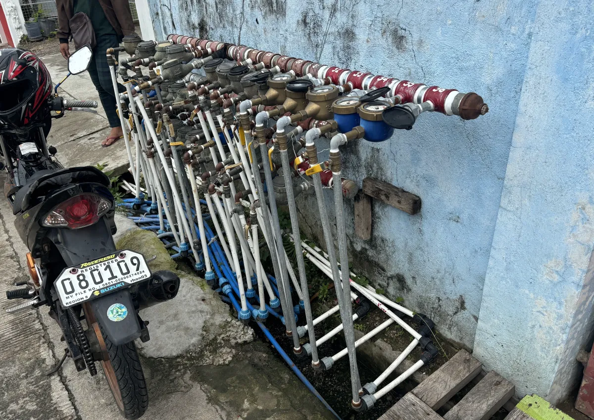 a motorcycle parked next to a row of pipes