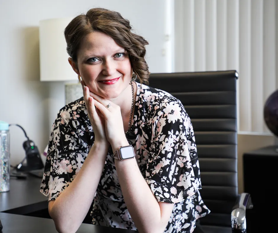 image of Elise Smith at her desk smiling 