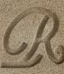 Close-up of the Dark Buff cast stone finish, a sandy color with a letter 'R' carved to show texture.