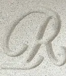 Close-up of the White cast stone finish, a color with a letter 'R' carved to show texture.