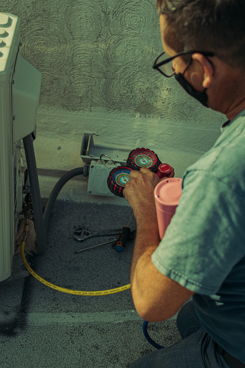 HVAC technician diagnosing an air-conditioning system