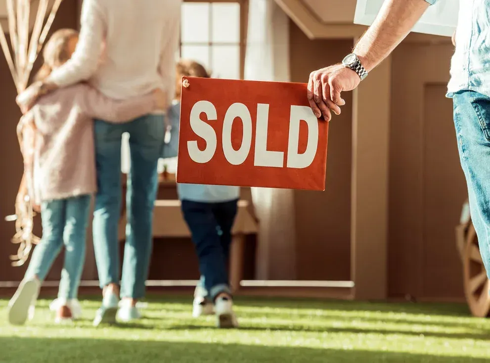 a bedroom with a green wall and a white bed