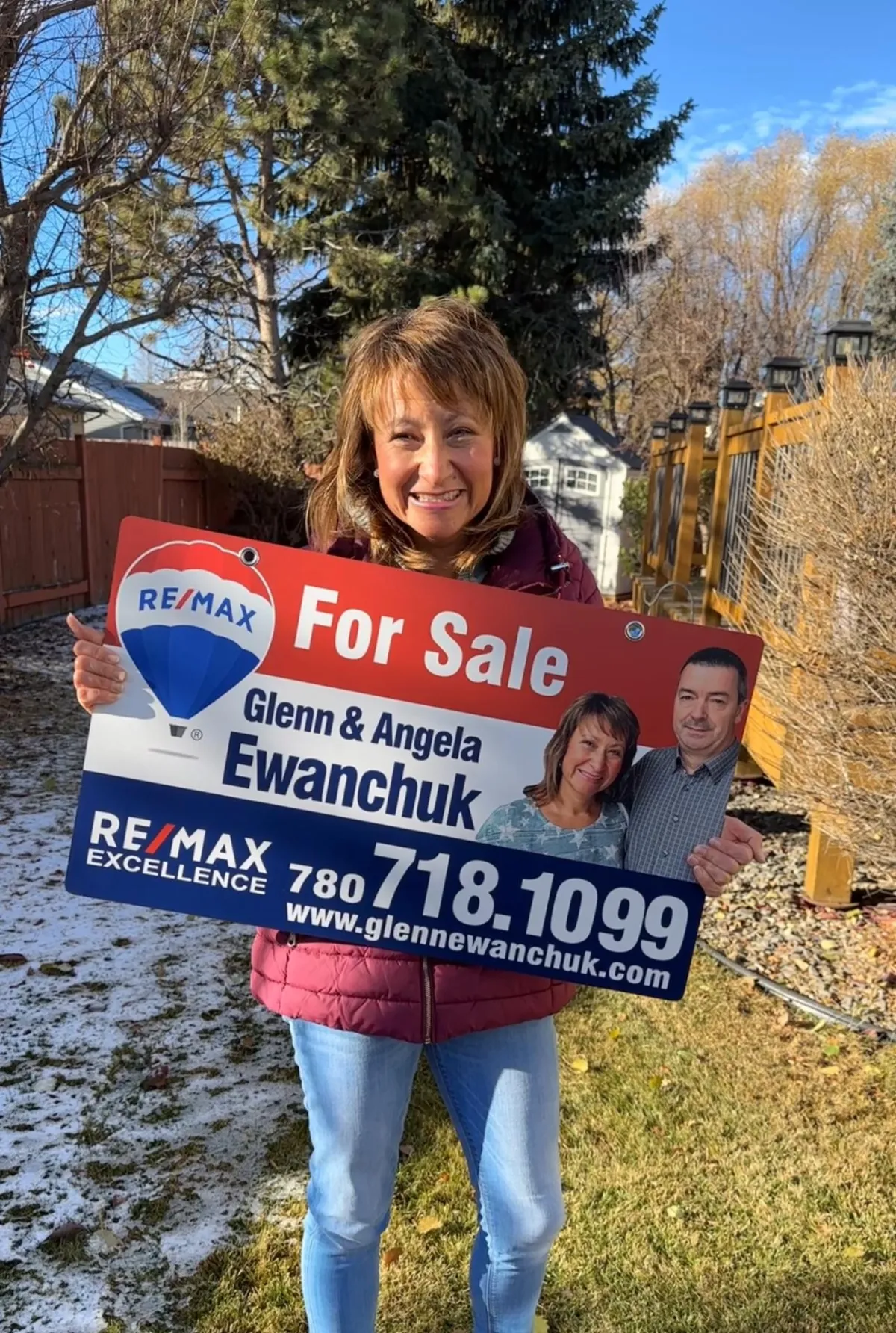 a bedroom with a green wall and a white bed